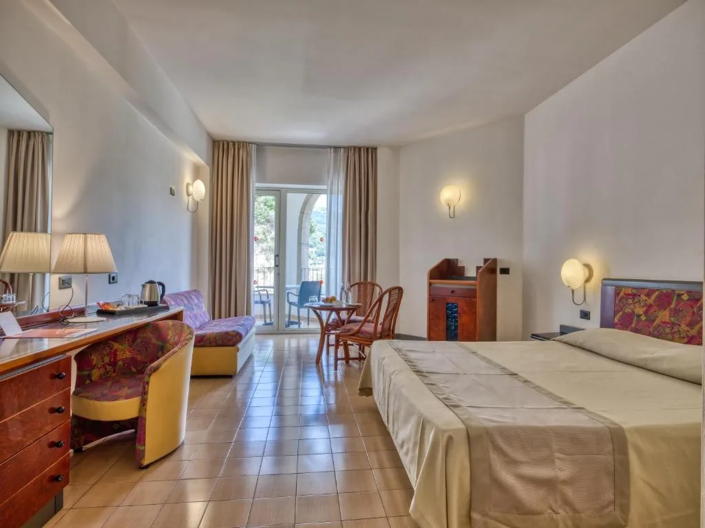 Ampia camera luminosa con letto matrimoniale, zona salotto e balcone