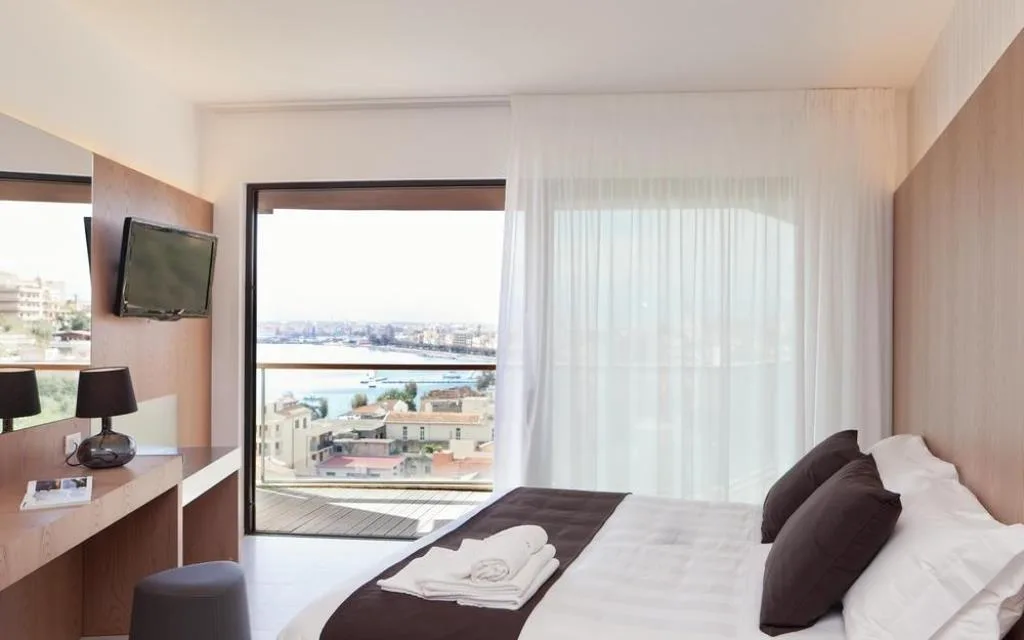 Camera moderna con scrivania e balcone affacciato sul porto e sulla città