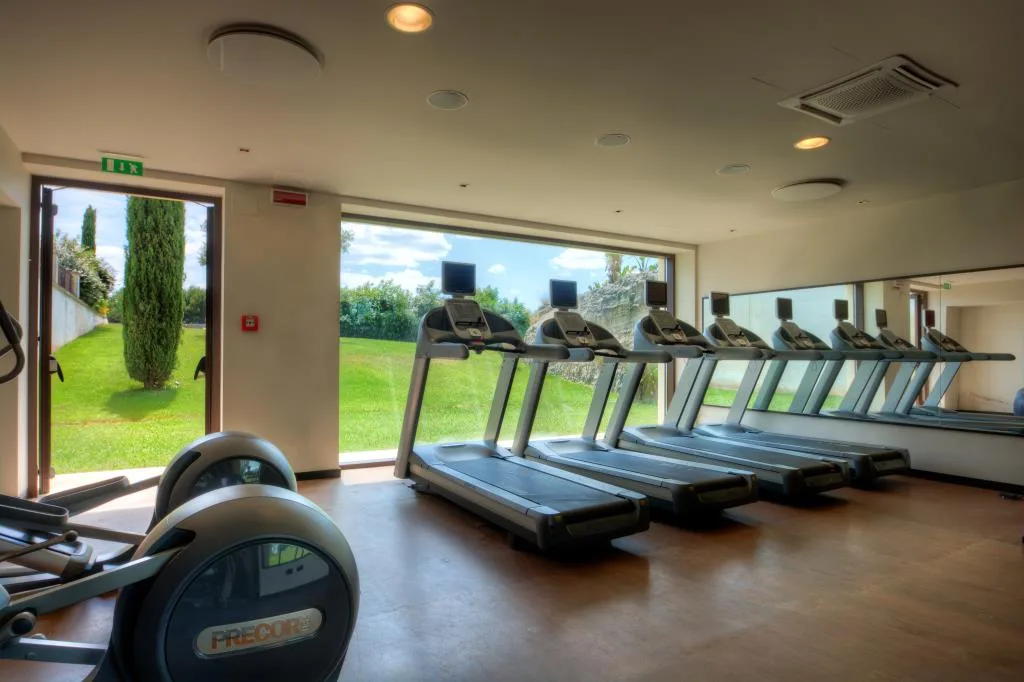 Sala fitness attrezzata con tapis roulant e vista sul giardino