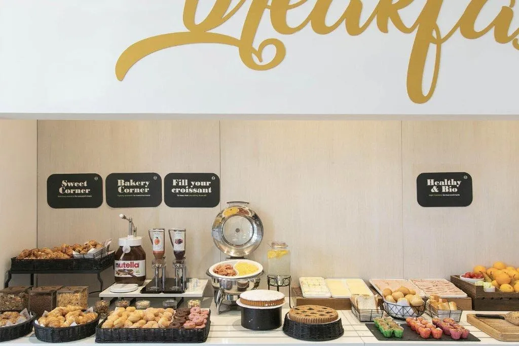 Buffet della colazione con dolci, croissant, frutta e angolo bakery