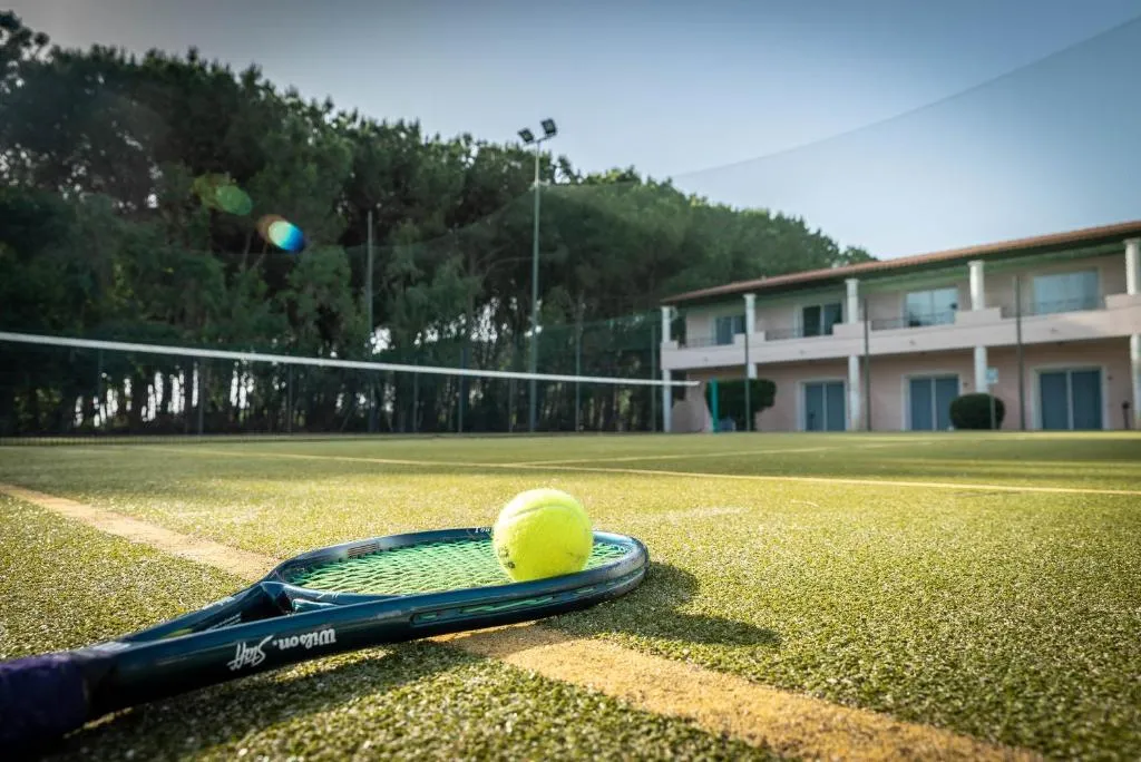 Campo da tennis con racchetta e pallina in primo piano