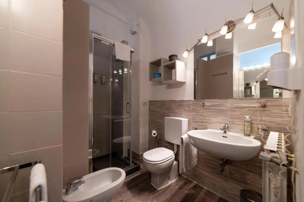 Bagno moderno con doccia, bidet, WC e lavabo con specchio illuminato